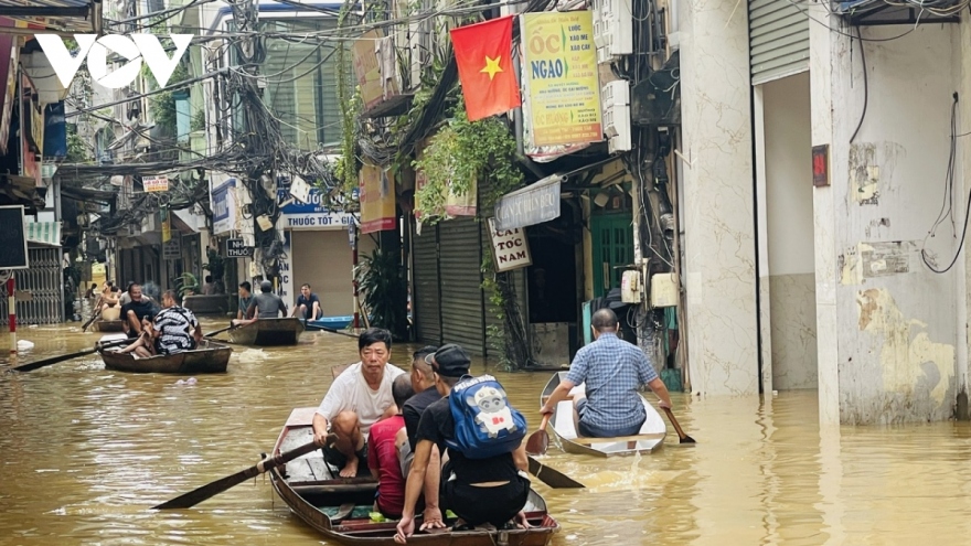 As floodwaters rise, Hanoians use boats for transportation, daily activities