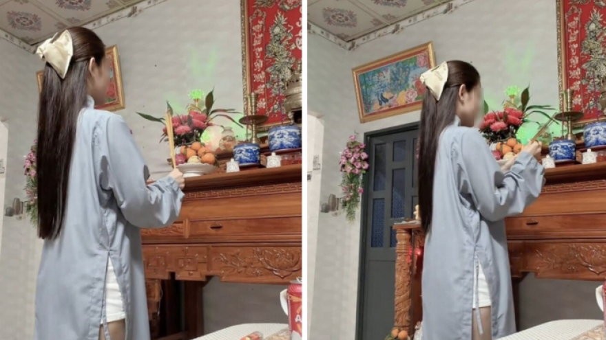 Cô gái mặc áo tràng, quần ngắn thắp hương gây tranh cãi