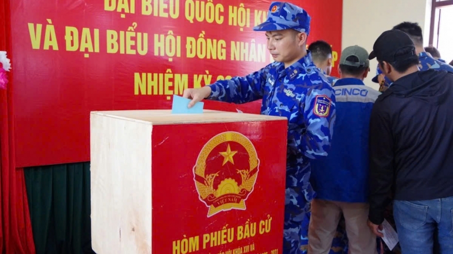 Coast Guard officers vote early while on duty at sea near Truong Sa