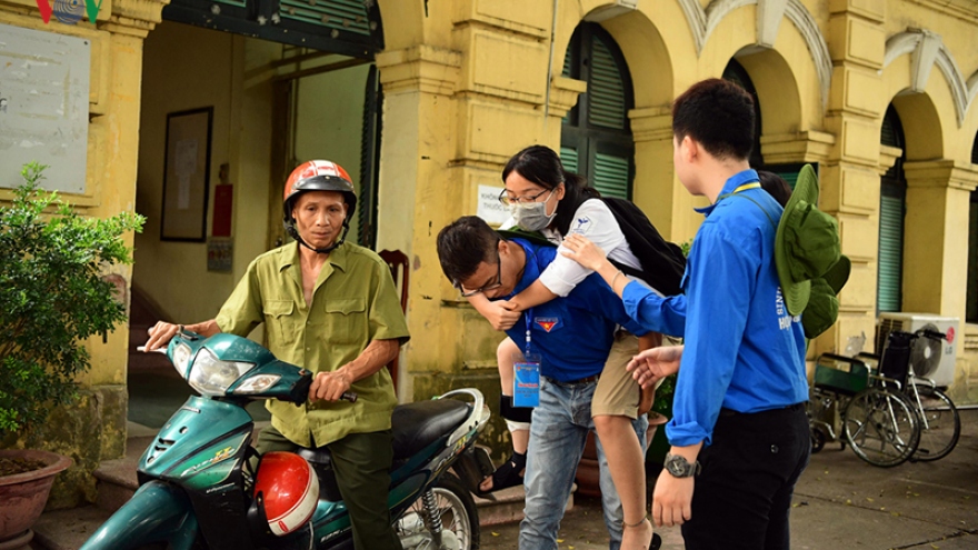 Student volunteers pitch in to help out for national high school exams