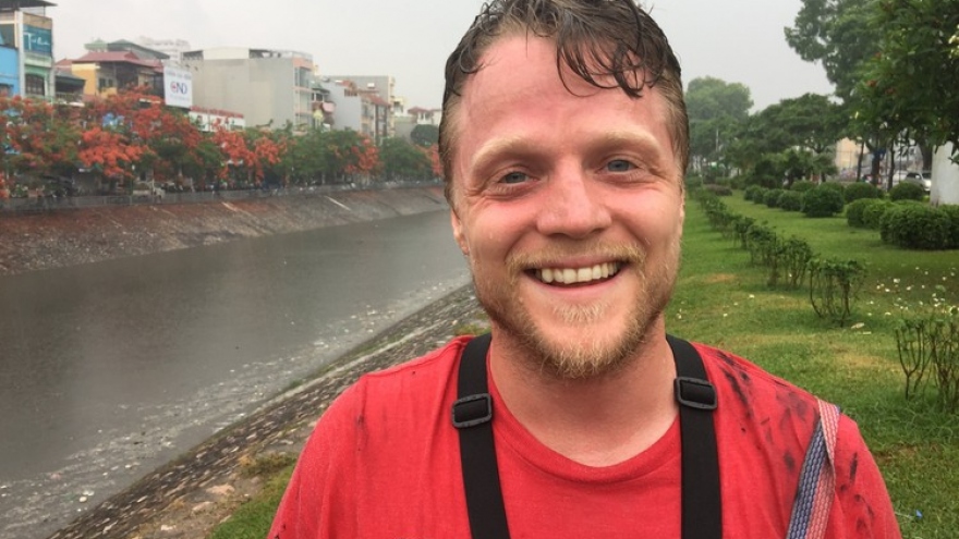 An American finds fame, lots of cockroaches in Hanoi’s mucky storm drains