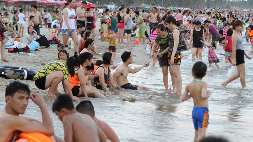 People flock to beaches for summer retreat