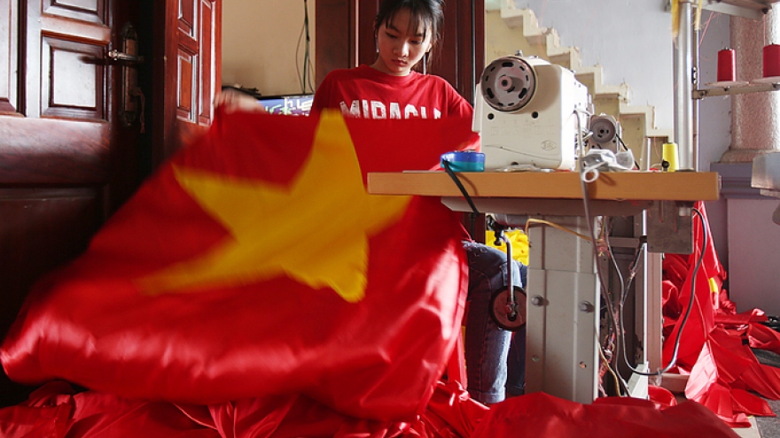 Workers toil through night on flags, banners as football fever grips 