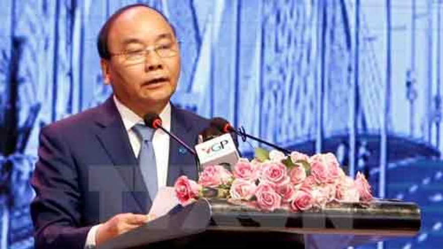 PM urges Hanoi to remove barriers for stronger development