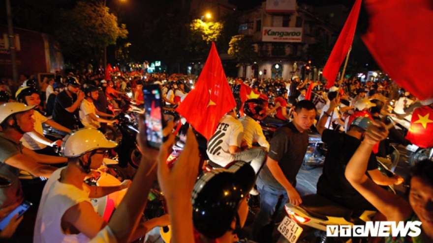 Football fans hit the streets of Hanoi in celebration after victory over Malaysia