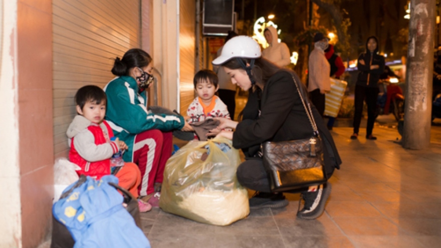 Huyen My on motorbike deliver Tet gifts to homeless people