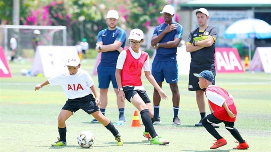 English football coaches train kids in Vietnam