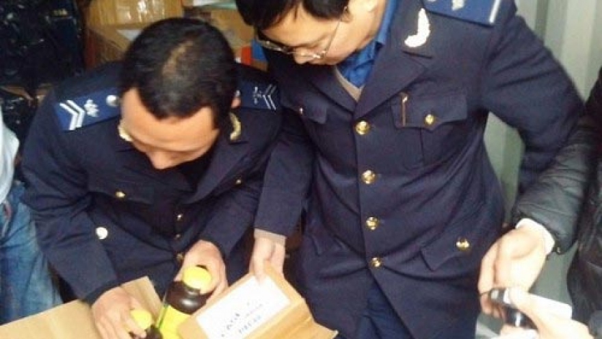 Customs officers hold container of foreign-made alcohol