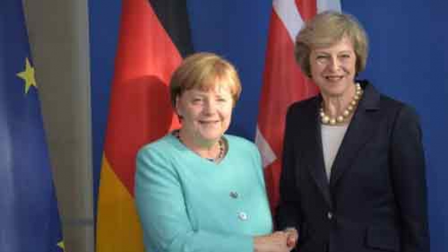 In Germany, May seeks to reassure on Brexit, warned over 'limbo'