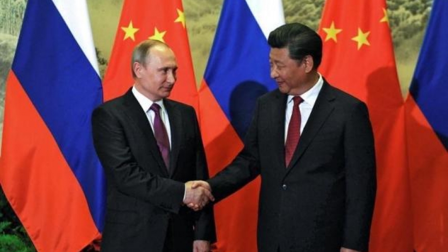 Russia secures energy deals, talks security with China as Putin visits