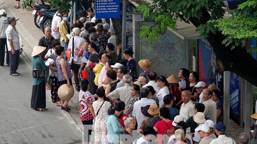Hundreds of old people queue to get free bus pass