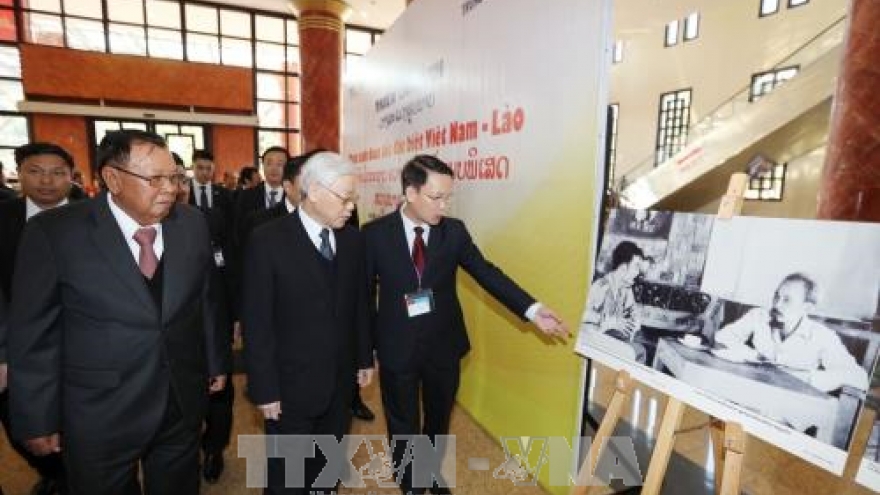 Vietnamese, Lao leaders attend exhibition on special solidarity
