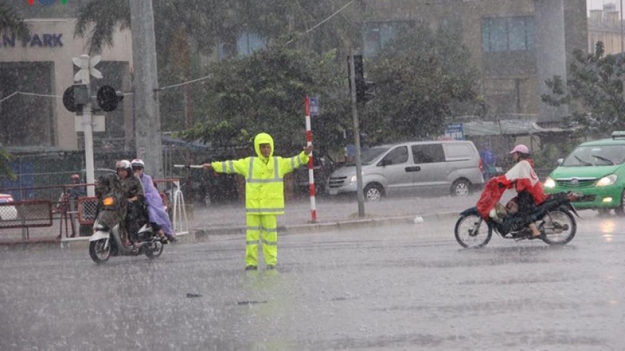 Torrential rain floods Hanoi streets