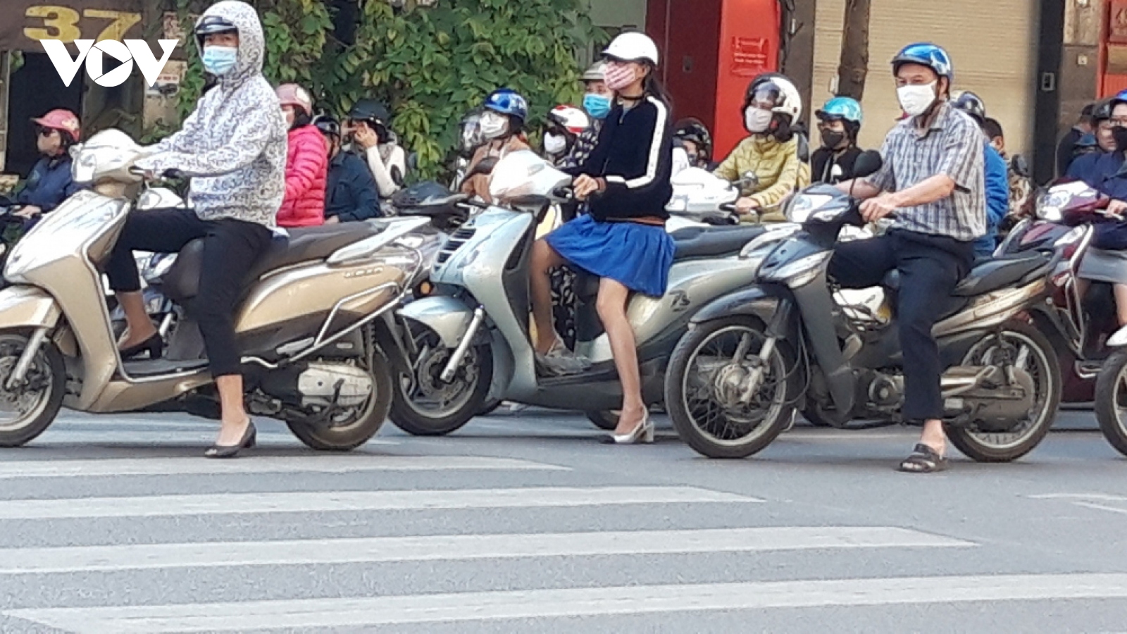 Locals follow face mask rules in public areas throughout Hanoi