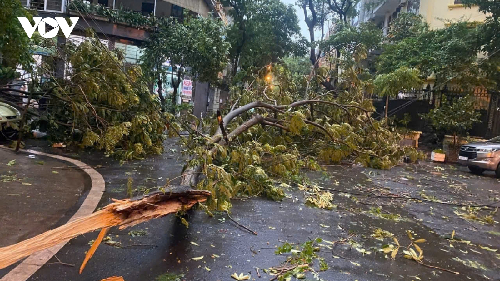 Trời Hà Nội tối sầm, mưa như trút, gió thổi bạt người đi xe máy trên đường