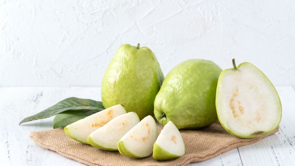 delicious-beautiful-guava-set-with-fresh-leaves-isolated-bright-white-wooden-table-background-close-up.jpg
