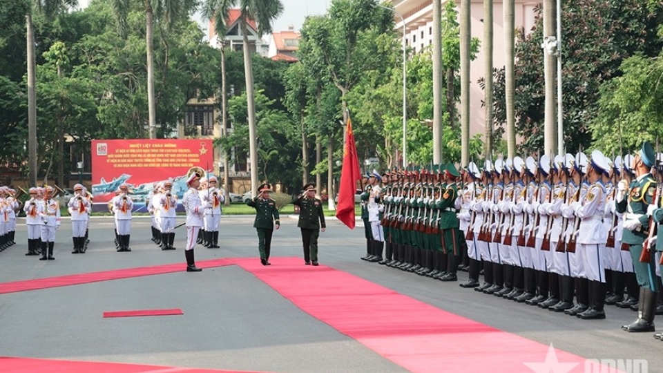 General Trinh Van Quyet and Lieutenant General Vongsone Inpanphim review the Vietnam People’s Army Honor Guard.jpg