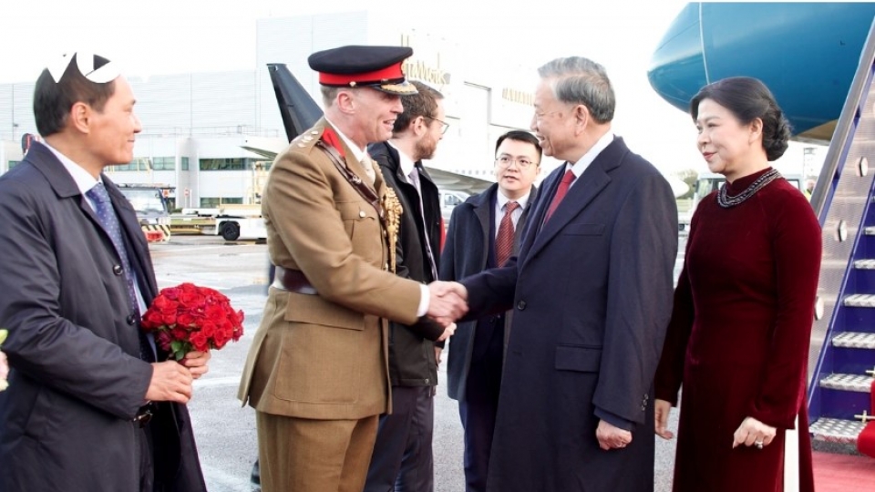 Party leader To Lam and his spouse arrive in London.jpg