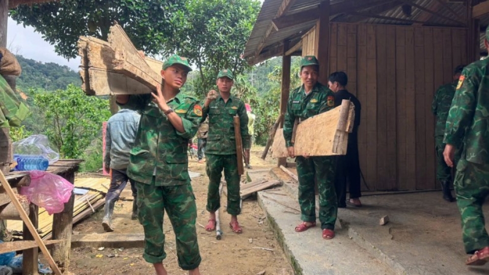 Border guards assist fishermen in bringing boats to safe shelter.jpg