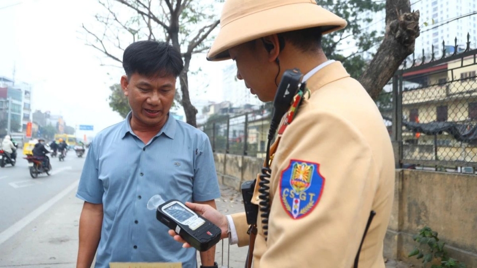 Traffic police conduct a breath alcohol test on a driver during the Lunar New Year holiday.jpg