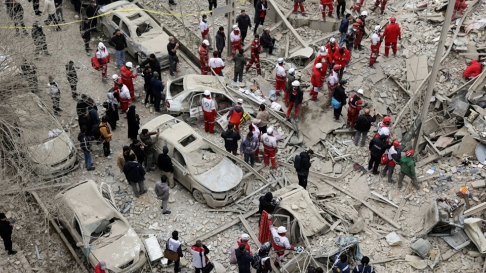 Rescue workers operate at the site of a residential building hit by an Israeli airstrike.jpg
