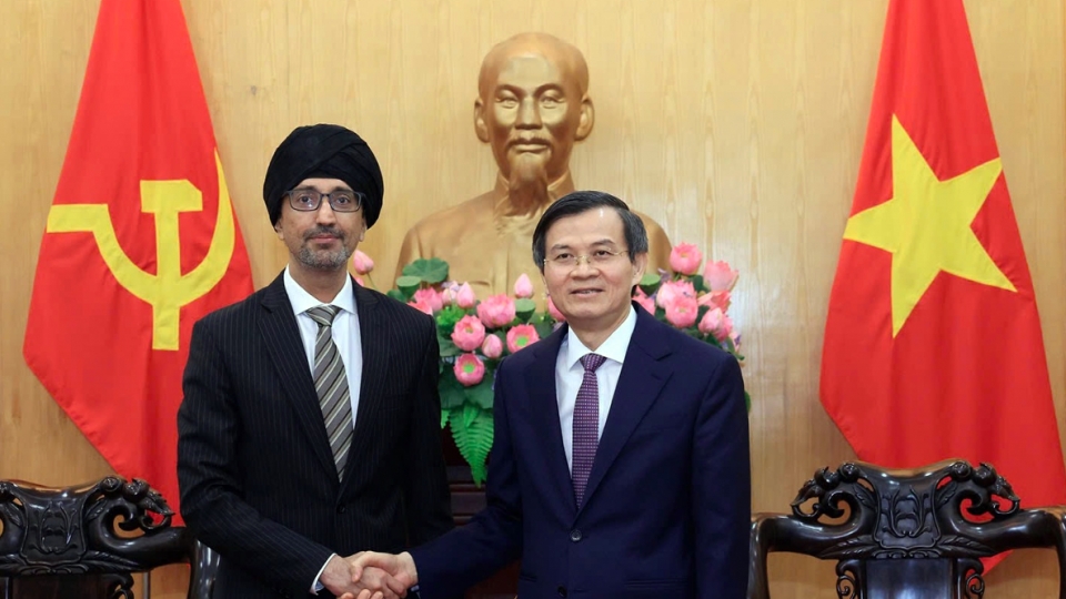Doan Minh Huan, Politburo member and director of the Ho Chi Minh National Academy of Politics, and Ambassador of Singapore to Vietnam Rajpal Singh..jpg