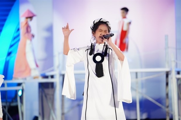 Singer Kieu Minh Tam, winner of The Voice Kid 2019 singing contest, performs at the opening ceremony of Vietnam Top Fashion & Hair 2020. Photo courtesy of N Group Media