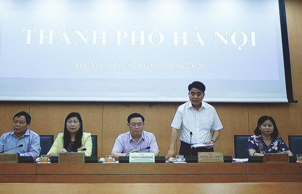 Chairman of the Hanoi People’s Committee Nguyen Duc Chung (standing) speaks at the online meeting on August 7 