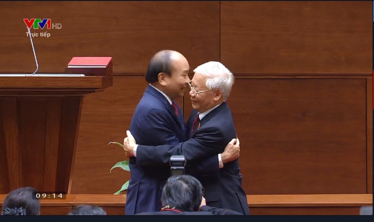 Party General Secretary Nguyen Phu Trong (R) congratulates the new State President on his election.