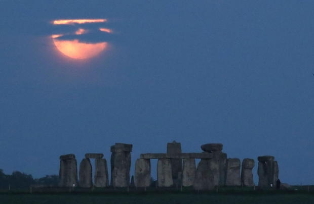Mặt trăng tròn phía sau vòng tròn đá Stonehenge gần Amesbury, Anh. Ảnh: Reuters