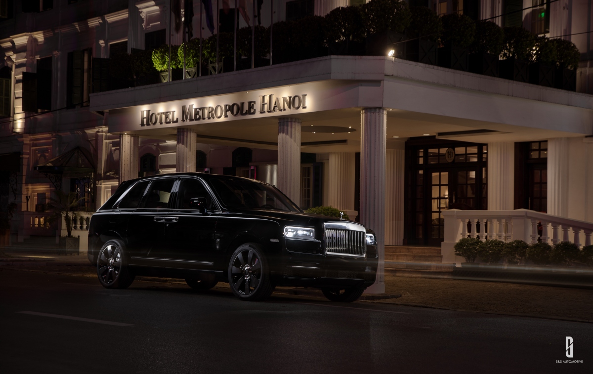 Premium AI Image  A black rolls royce is driving on a road at night