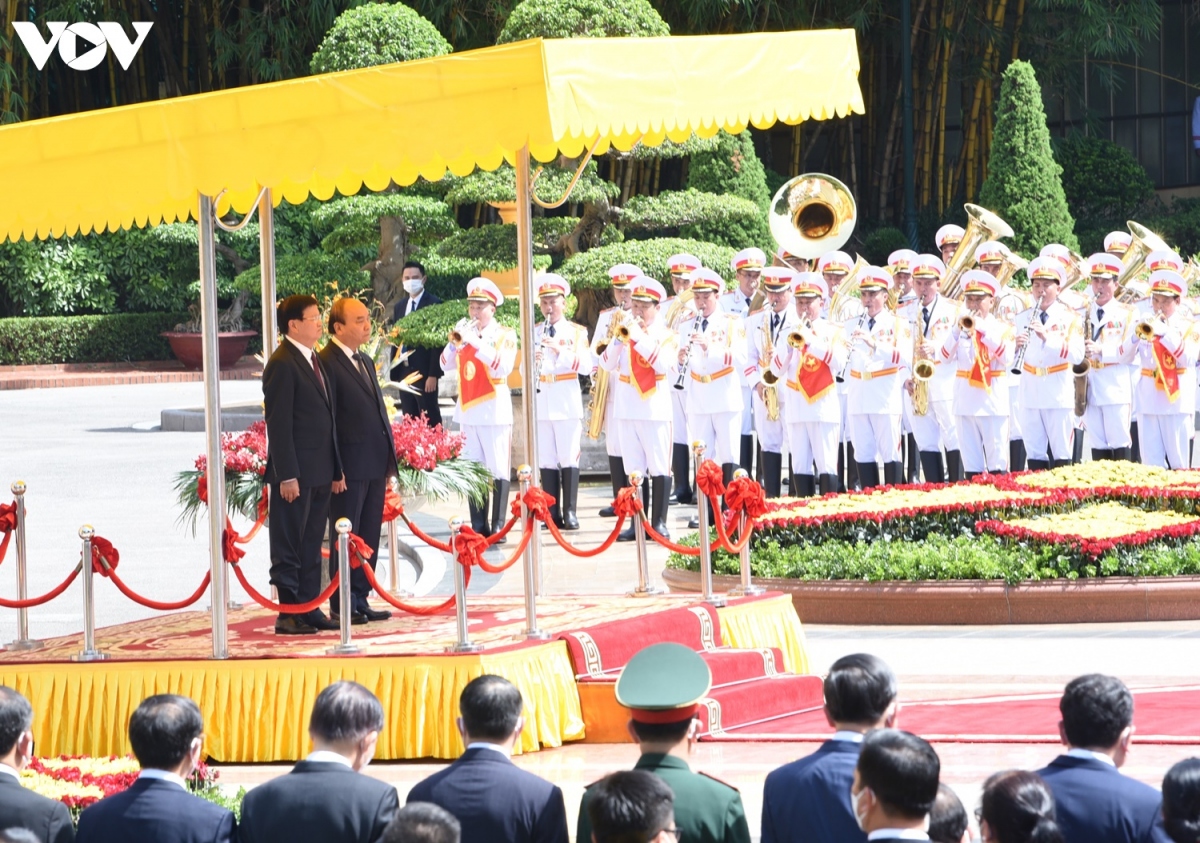 Sáng 28/6, Lễ đón chính thức Tổng Bí thư, Chủ tịch nước Lào - Thongloun Sisoulith cùng Đoàn đại biểu cấp cao Đảng, Nhà nước Lào được tổ chức trọng thể tại Phủ Chủ tịch theo nghi thức cao nhất dành cho nguyên thủ quốc gia. Chủ tịch nước Nguyễn Xuân Phúc và Phu nhân chủ trì lễ đón. Trong ảnh: Thủ tướng Nguyễn Xuân Phúc và Tổng Bí thư, Chủ tịch nước Lào - Thongloun Sisoulith đứng trên bục danh dự. Quân nhạc cử Quốc thiều hai nước.