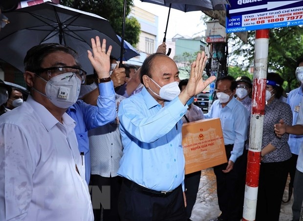 state president visits pandemic-hit hcm city picture 1