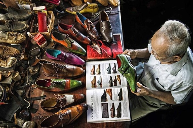 A photo entitled “90-year-old shoemaker” taken by Viet Van wins a bag medal during the PX3 Paris Photography Prize 2021.