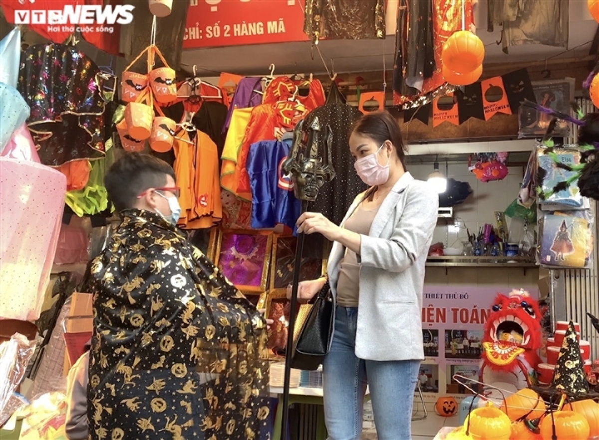 A child is eager to wear a specially designed costume and mask to celebrate Halloween.