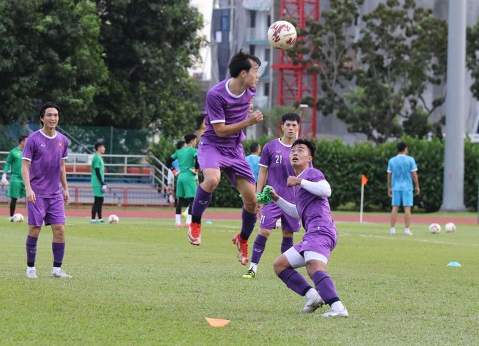 The footballers who took part in the game against Laos go through some light exercise.