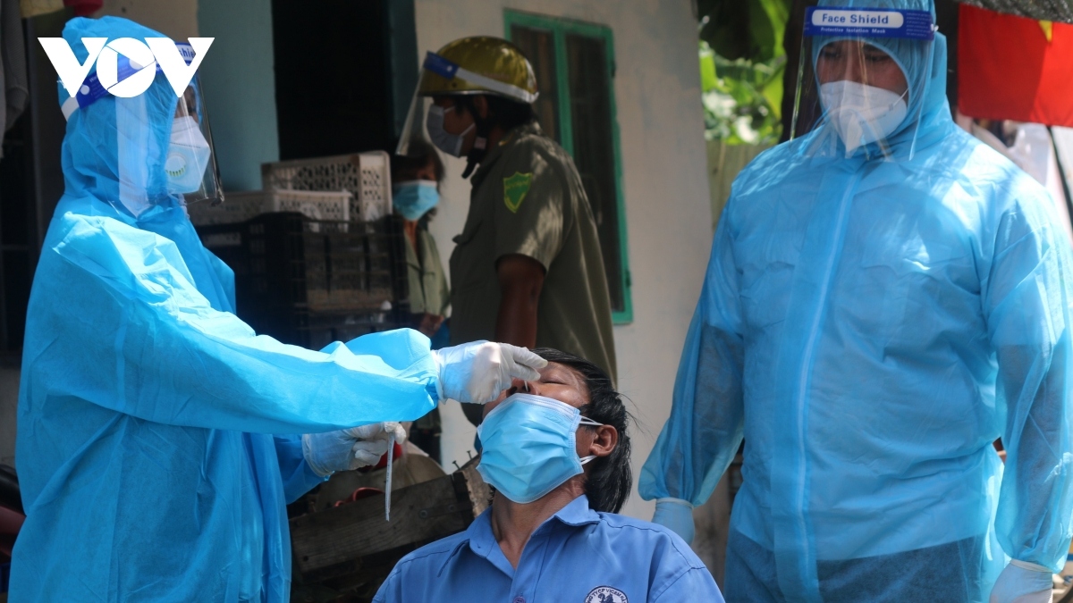 Taking nasal swabs for COVID-19 testing in HCM City.