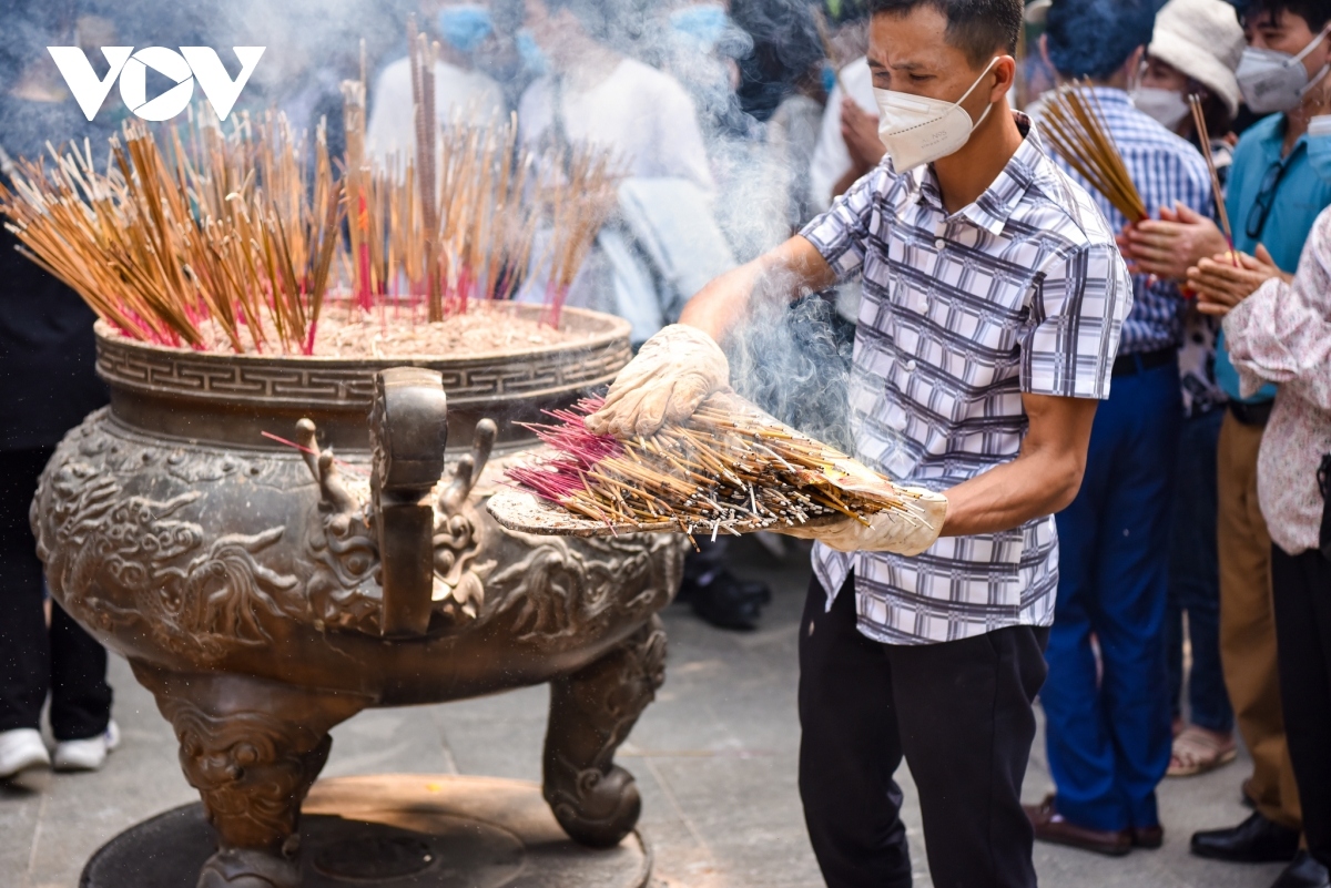 Staff at Ha Temple constantly have to remove incense sticks due to the excessive number being placed there.