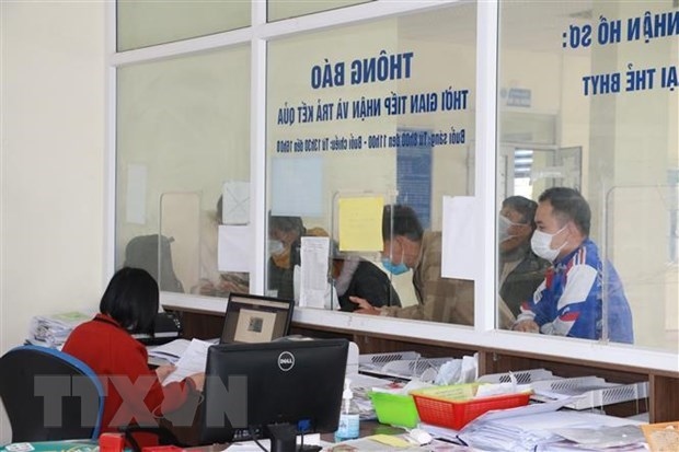 Workers come to handle procedures at the Vietnam Social Security branch in Quynh Luu district, Nghe An province.