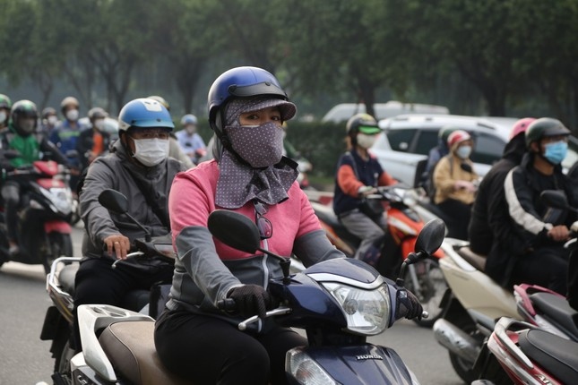 hcm city residents bask in warm clothes as temperatures drop picture 9