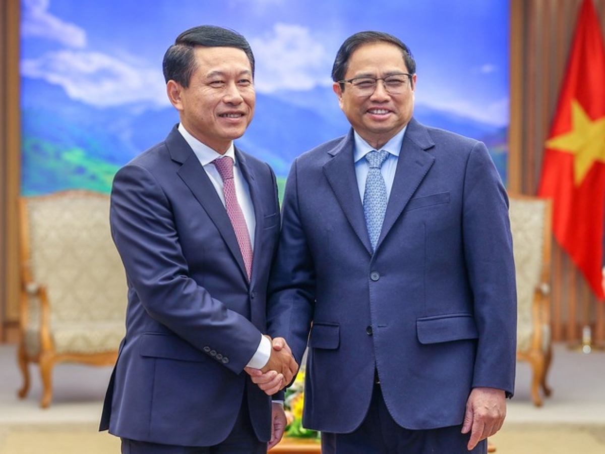 pm chinh hosts lao deputy pm, foreign minister picture 1