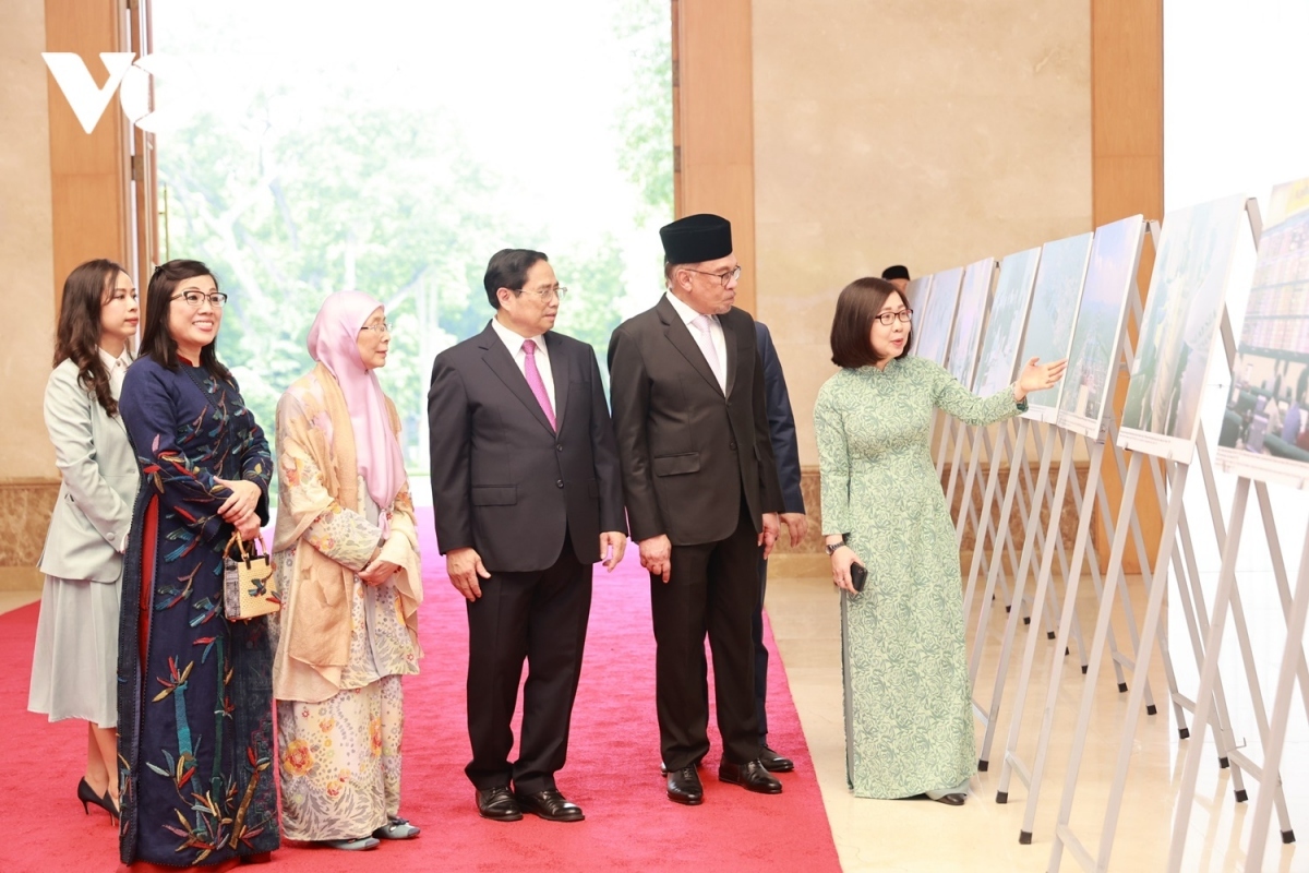 PM Chinh and his Malaysian counterpart visit a photo exhibition on the joint friendship relations.