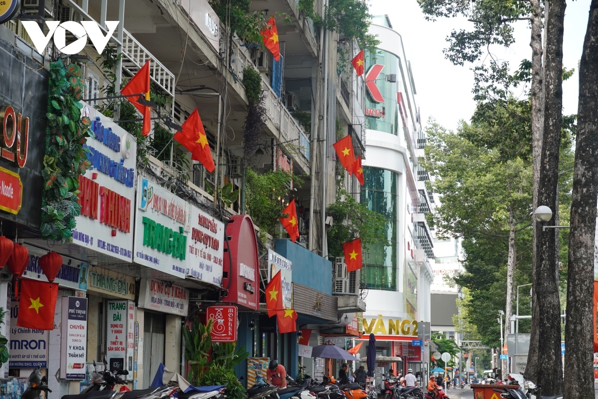 Small alleys, streets, and old apartment blocks in the southern city are dressed up in red by plenty of national flags.