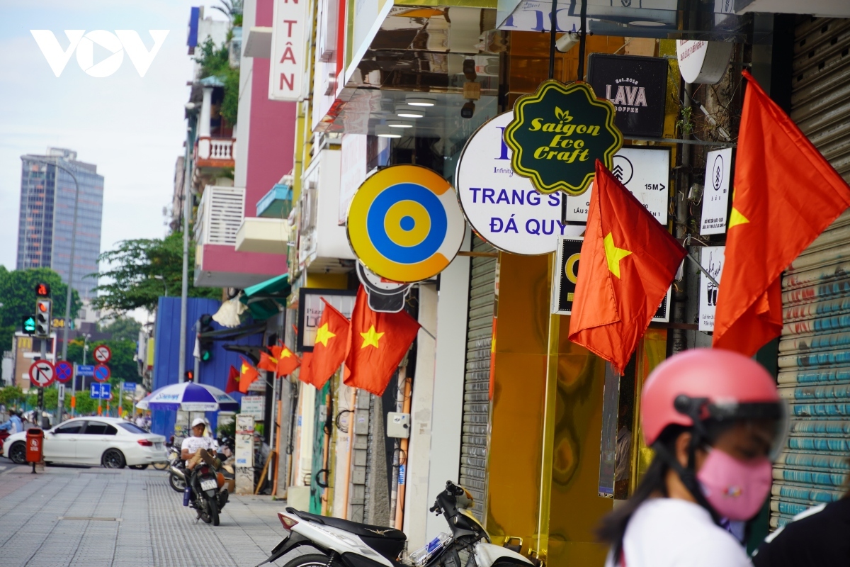 Several shops throughout the city are hanging red flags to celebrate the special day