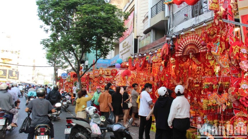 bustling city street gearing up for coming tet holiday picture 1