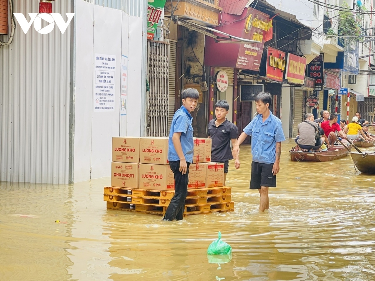 as floodwaters rise, hanoians use boats for transportation, daily activities picture 11