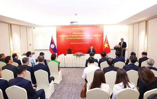 pm works with vietnamese representative agencies in laos picture 1