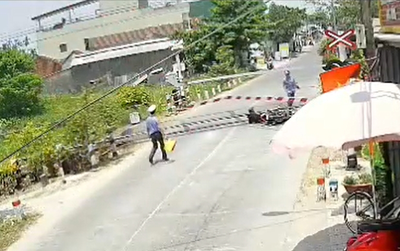 nguoi dan ong lao xe may tong gay gac chan khi tau sap chay qua hinh anh 1