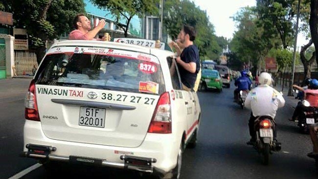 3 foreigners caught partying on cab roof on HCMC street