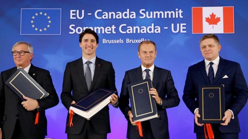 EU, Canada sign free trade deal but battle not over